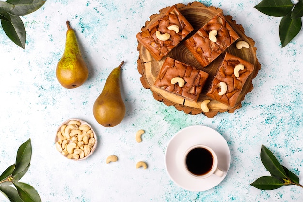 Homemade rustic chocolate cake with pear and cashew nuts