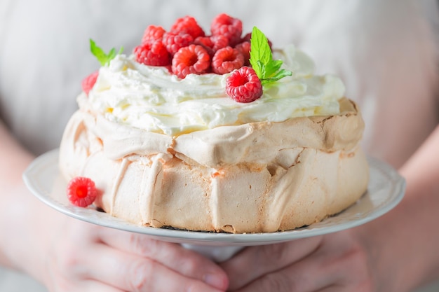 Homemade and rustic Pavlova cake with berries and meringue