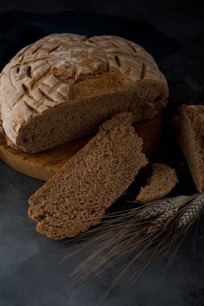 Homemade rye round bread on a dark background, selective focus