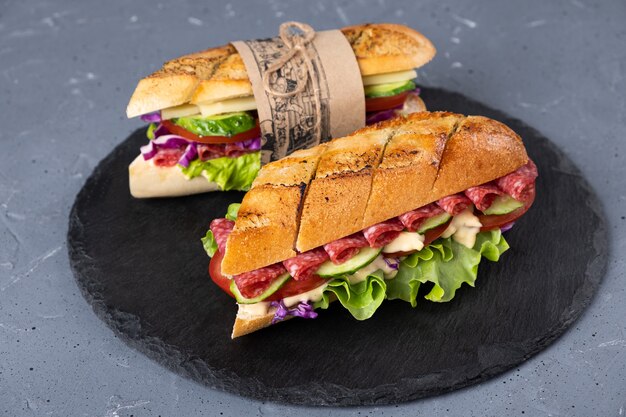 Homemade sandwich on a gray background and a board