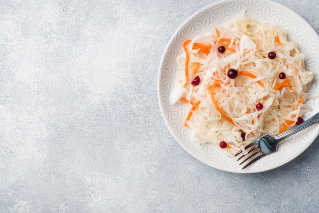 Homemade sauerkraut with carrots and cranberries in plate