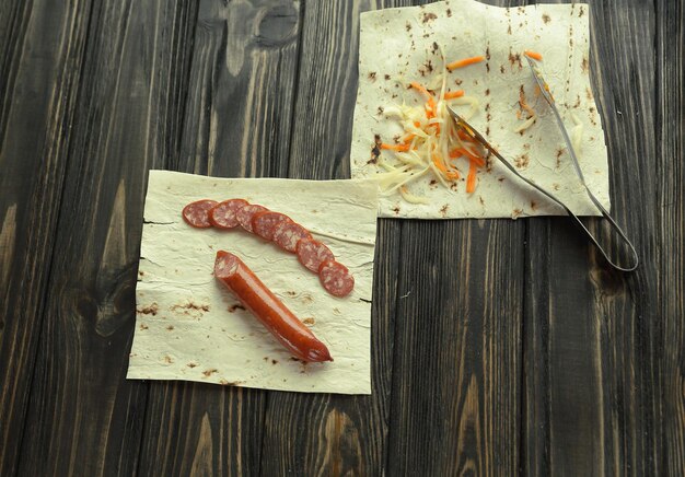 Homemade sausage with pita bread on wooden background