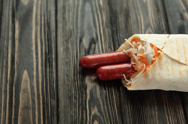 Homemade sausages in pita bread on wooden background.photo with copy space.