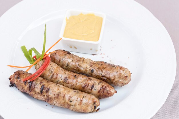 Homemade sausages, served with mustard and decorated with herbs