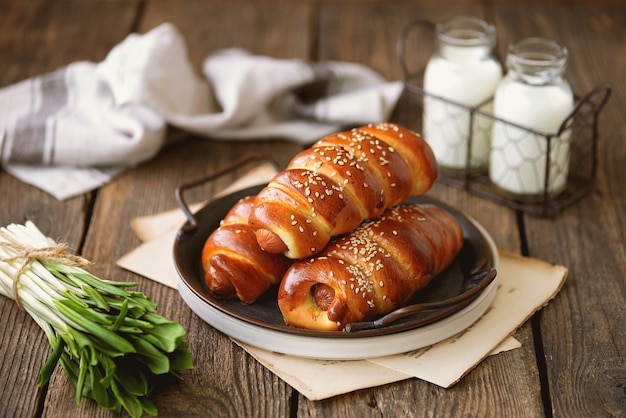 Homemade sausages in yeast dough with sesame seeds