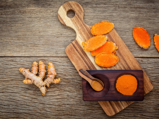 Homemade scrub curcumin powder on old wooden background.