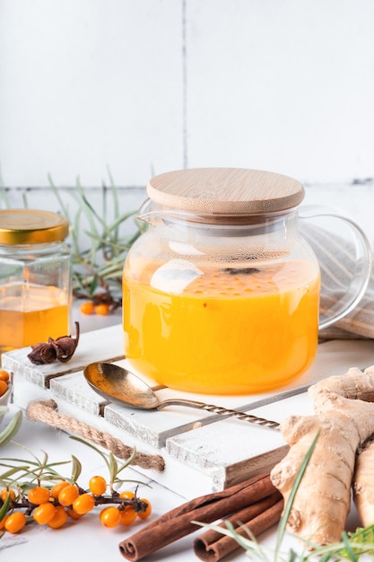 Photo homemade sea buckthorn tea with honey ginger and spices