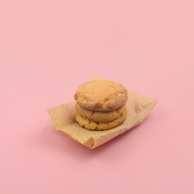 Homemade shortbread cookies stacked on a pink background