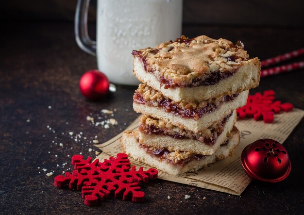 Homemade shortcrust raspberry pie with crumble on dark stone concrete table background. 