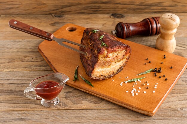 Homemade Smoked Barbecue Beef Brisket on wooden cutting board before cutting.