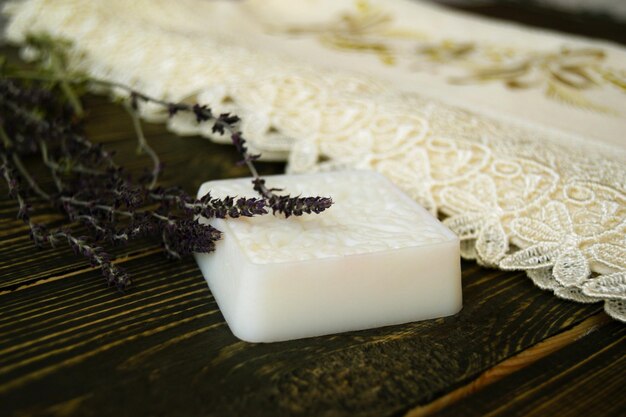 Homemade soap with herbs on wooden background