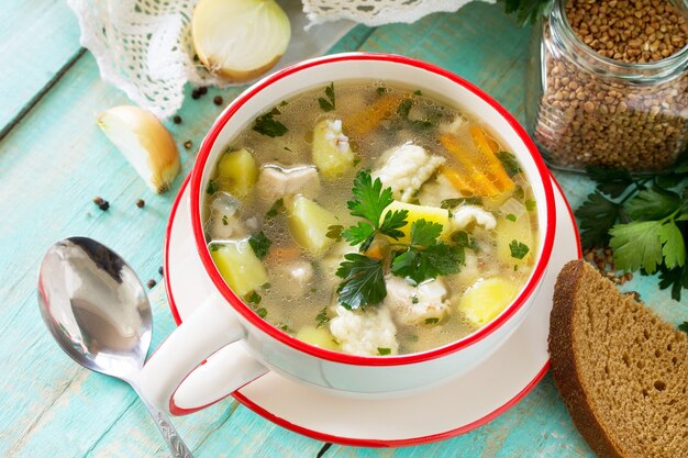 Homemade soup with buckwheat and pasta dumplings on the kitchen table