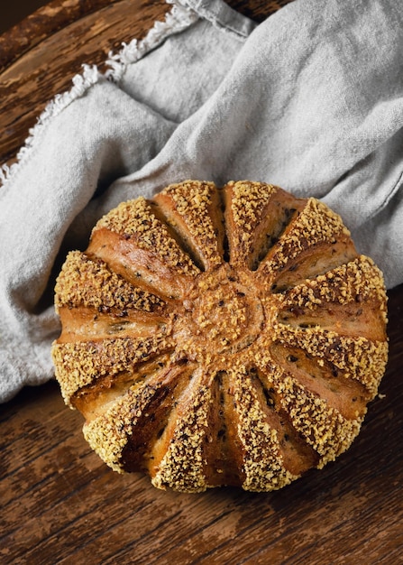 Homemade sourdough bread loaf of barley and corn flour on a nature linen tablecloth. Healthy food