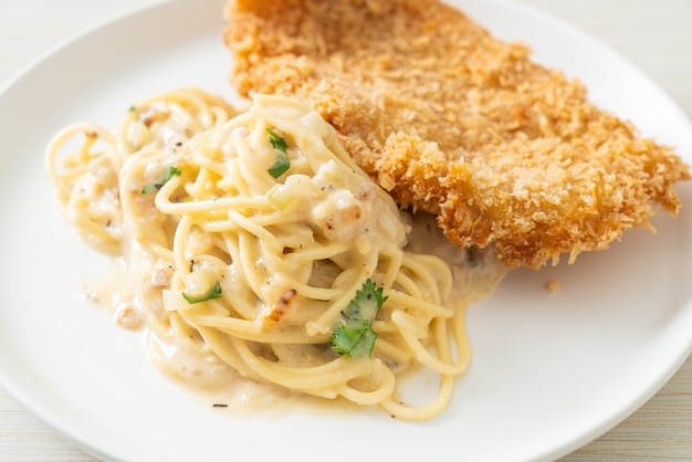 homemade spaghetti pasta white cream sauce with fried fish