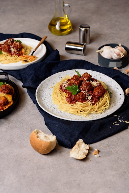 Homemade spaghetti or pasta with meatball and cheese in tomato sauce  placed in a white dish.