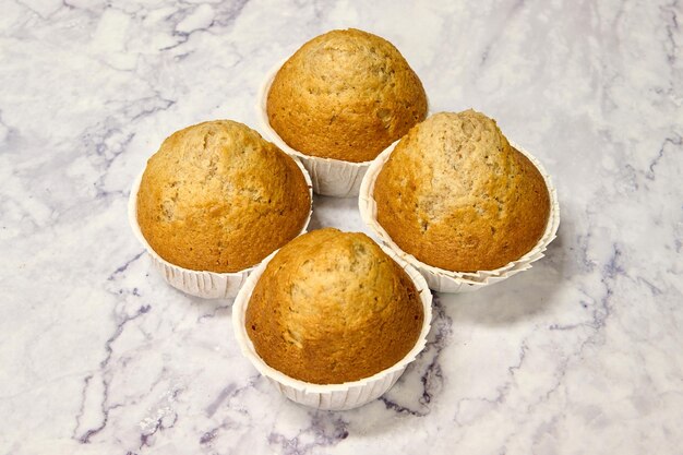 homemade spelled muffins on white marble