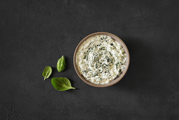 Homemade spinach dip served in the bowl top view