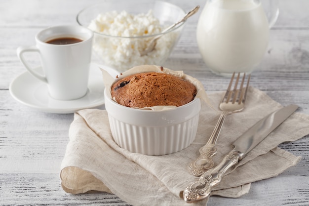 Homemade sponge cake with dried cranberries and cup of coffee.Selective focus on the sponge cake