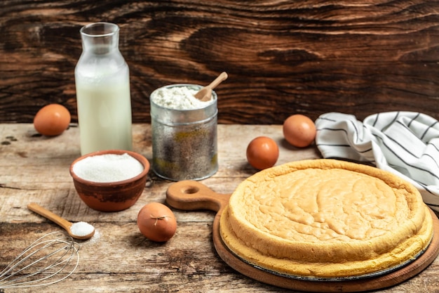 Homemade sponge cake with ingredients on a white wooden table Bakery background concept banner menu recipe place for text