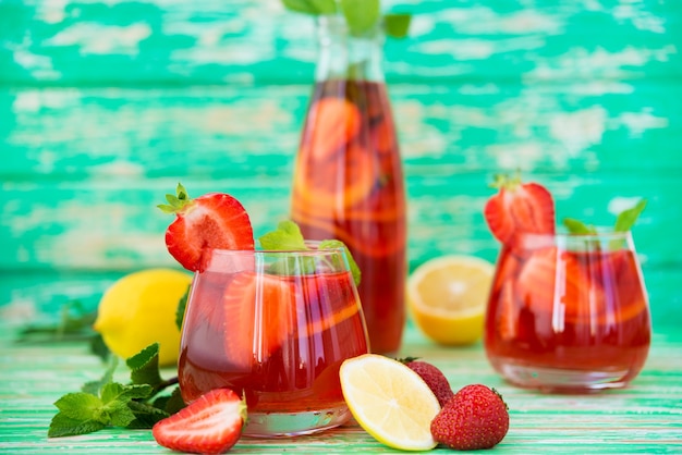 Homemade strawberry lemonade on a rustic background, a refreshing summer drink, selective focus