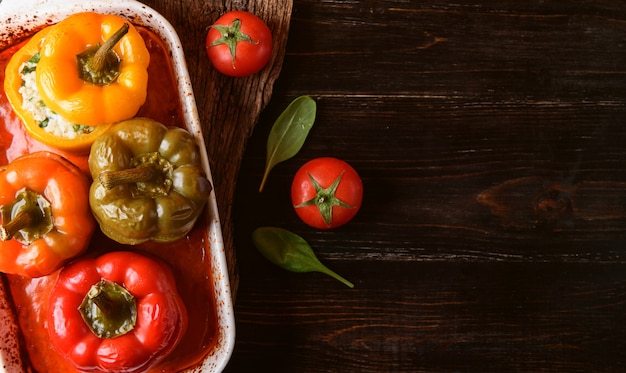 Homemade, stuffed peppers. with a filling of basil, spinach, cheese and spices. with gravy from fresh home-made tomatoes. made in a rustic style.