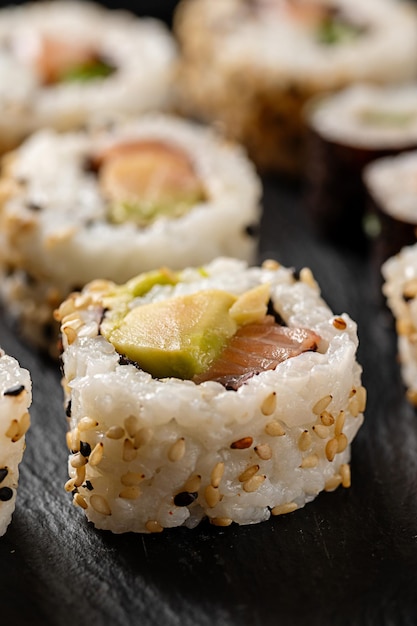 Homemade sushi rolls closeup with salmon shrimp avocado