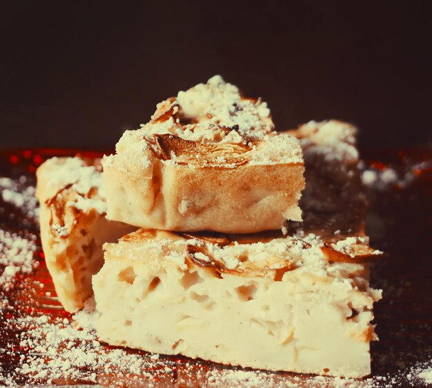 Homemade sweet apple pie with cinnamon and and powdered sugar