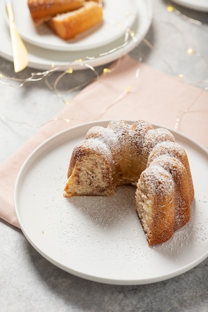 Homemade sweet bundt cake with powdered sugar, selective focus image