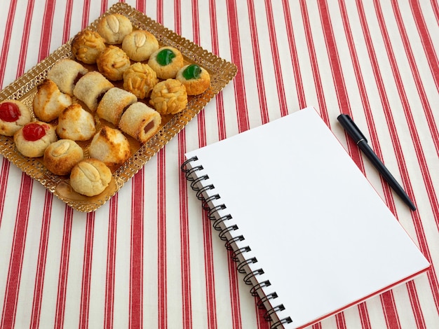 Homemade sweet panellets dessert a typical pastry from Catalonia Spain on the All Saints festival Notepad and pen for copy space