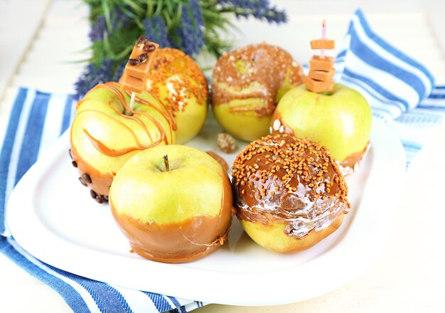 Homemade taffy apples, on napkin, on wooden background