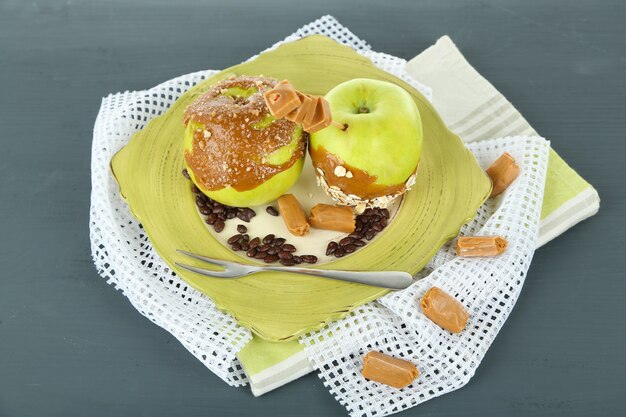 Homemade taffy apples, on napkin, on wooden table