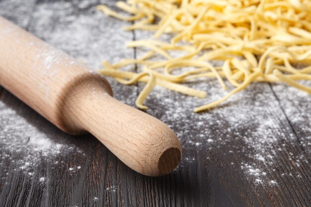 Homemade tagliatelle pasta and cutting board close up