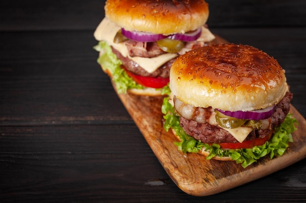 Homemade tasty burgers with big beef cheese tomato bacon and lettuce With copy space