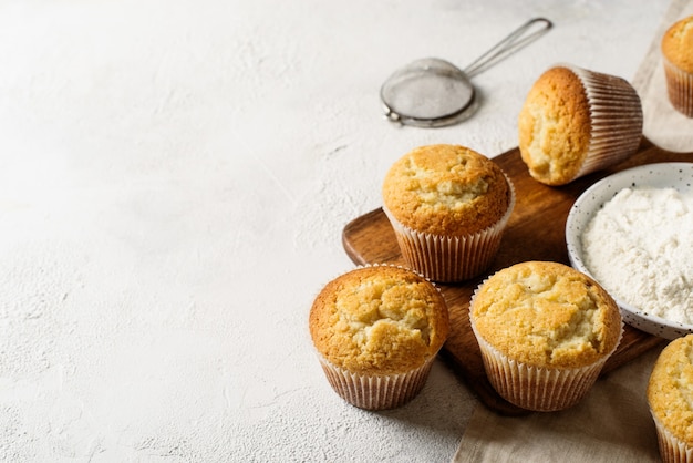 Homemade tasty miffins on white background, copy space, top view