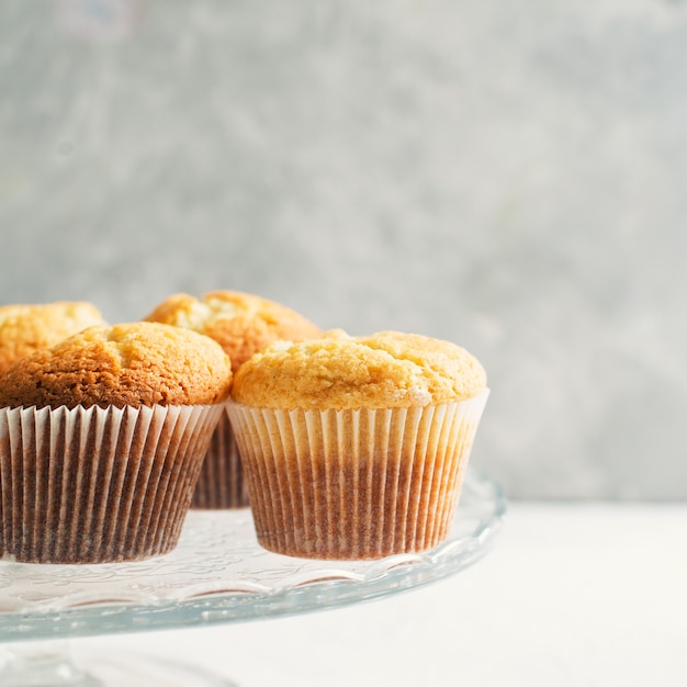 Homemade tasty miffins on white background, copy space