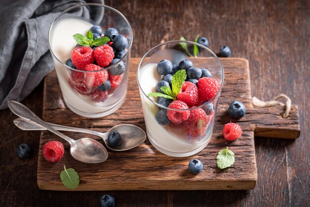 Homemade and tasty Panna Cotta served with berries in glass