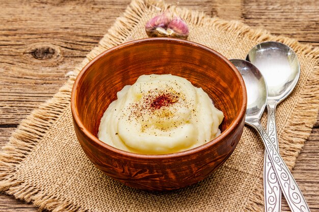 Homemade Thanksgiving garlic mashed potatoes with salt and pepper. Sackcloth napkin