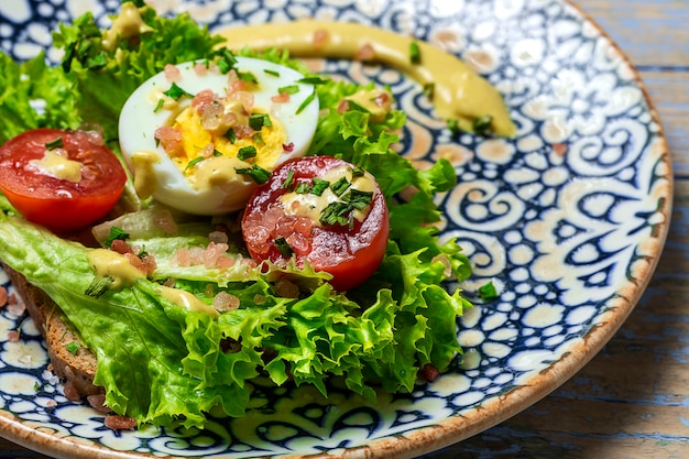 Homemade toasted bread with letucce salad,tomatoes,egg and mustard