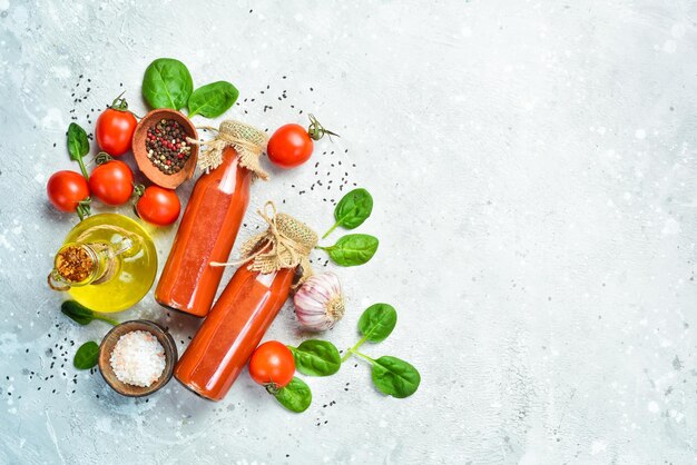 Homemade Tomato Juice in a Glass Bottle Top view On a stone background