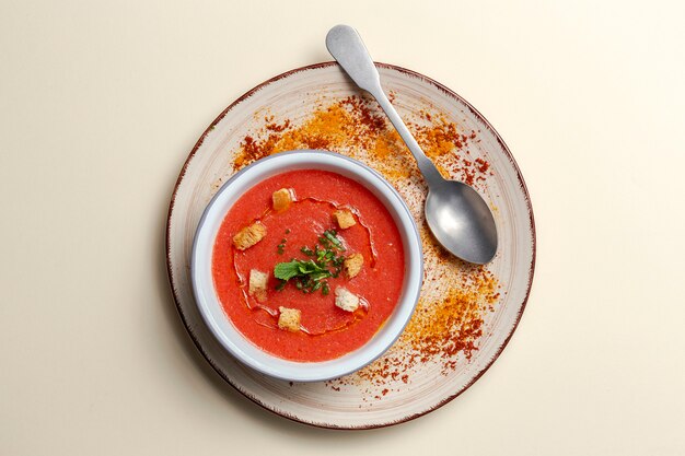 Homemade tomato soup with bread, mint and olive oil
