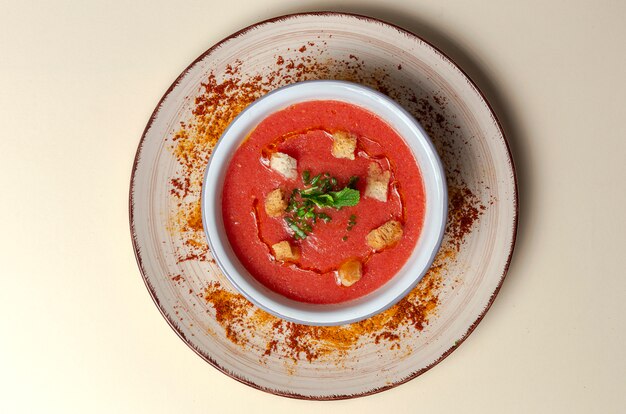 Homemade tomato soup with bread, mint and olive oil