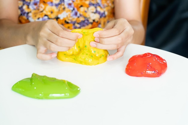 Photo homemade toy called slime, kids having fun and being creative by science experiment