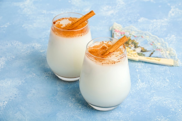 Homemade traditional mexican rice Horchata in a glass and maracas