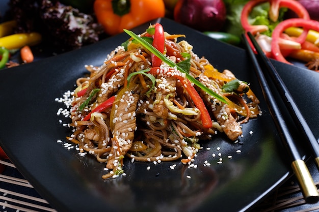 Homemade traditional oriental food. buckwheat noodles meat and vegetables meal.