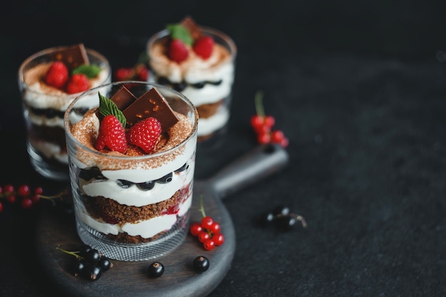 Homemade trifle dessert with raspberries, black currants, and cream cheese