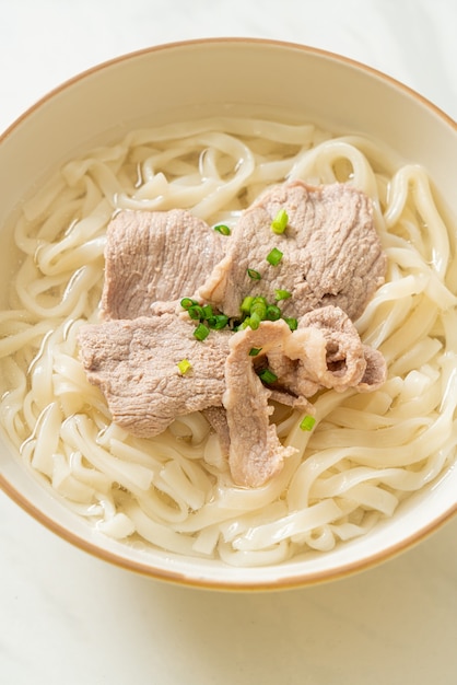 homemade udon ramen noodles with pork in clear soup