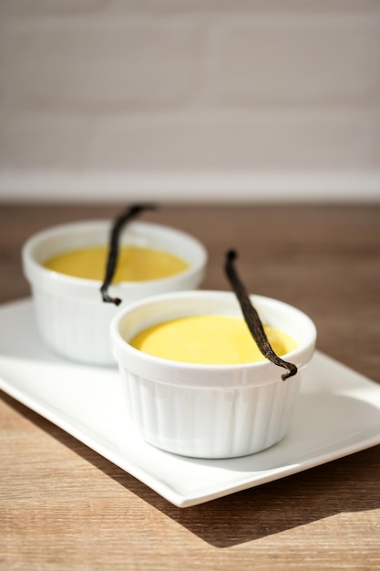 Homemade vanilla custard on wooden table