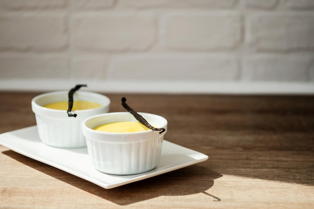 Homemade vanilla custard on wooden table