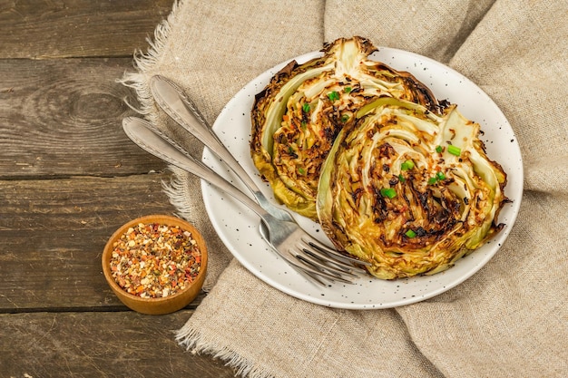 Homemade vegan cabbage steaks with herbs and spices Healthy food ready to eat on a baking sheet