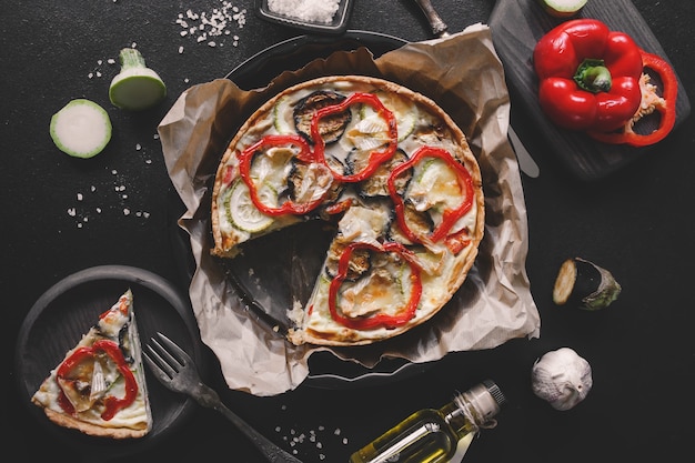 Homemade vegetable quiche with courgette zucchini eggplant pepper and brie